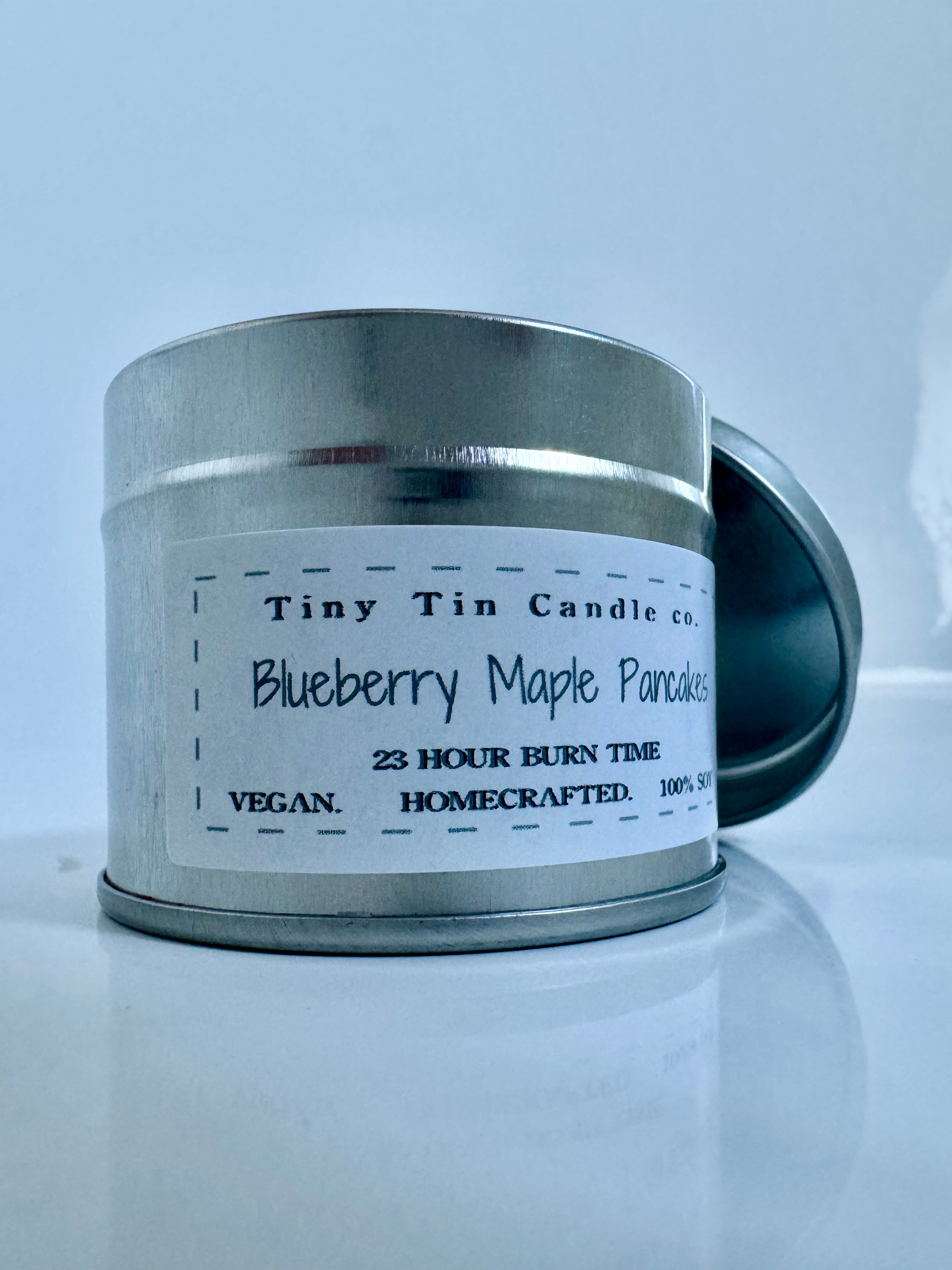 A homemade 'Blueberry Maple Pancakes' scented candle from Tiny Tin Candle Co, front of candle