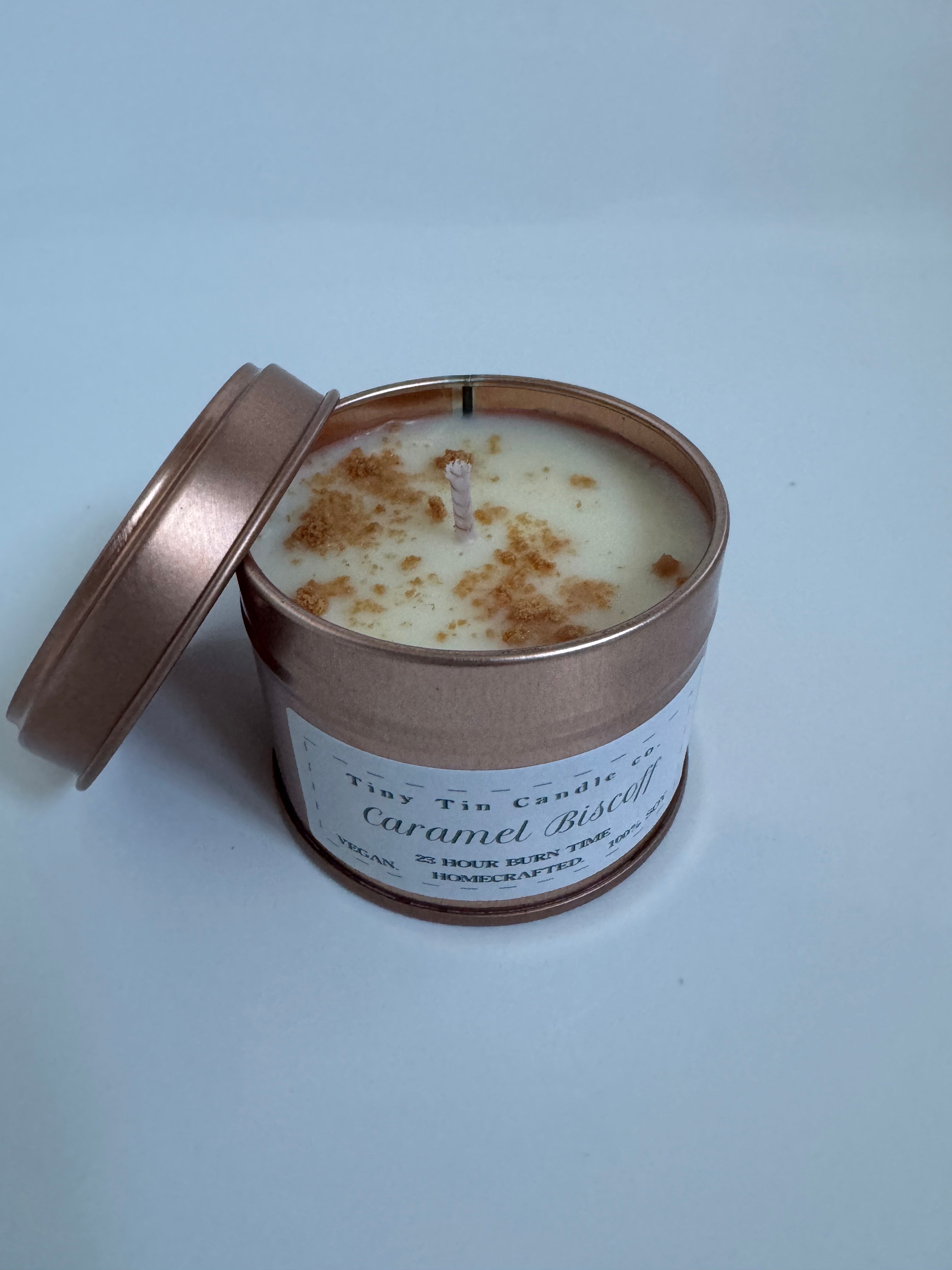 homemade candle labeled 'Caramel Biscoff' by Tiny Tin Candle with a 23-hour burn time, advertised as vegan and handcrafted. top and front of candle