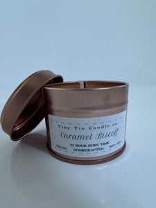 homemade candle labeled 'Caramel Biscoff' by Tiny Tin Candle with a 23-hour burn time, advertised as vegan and handcrafted. front of candle 