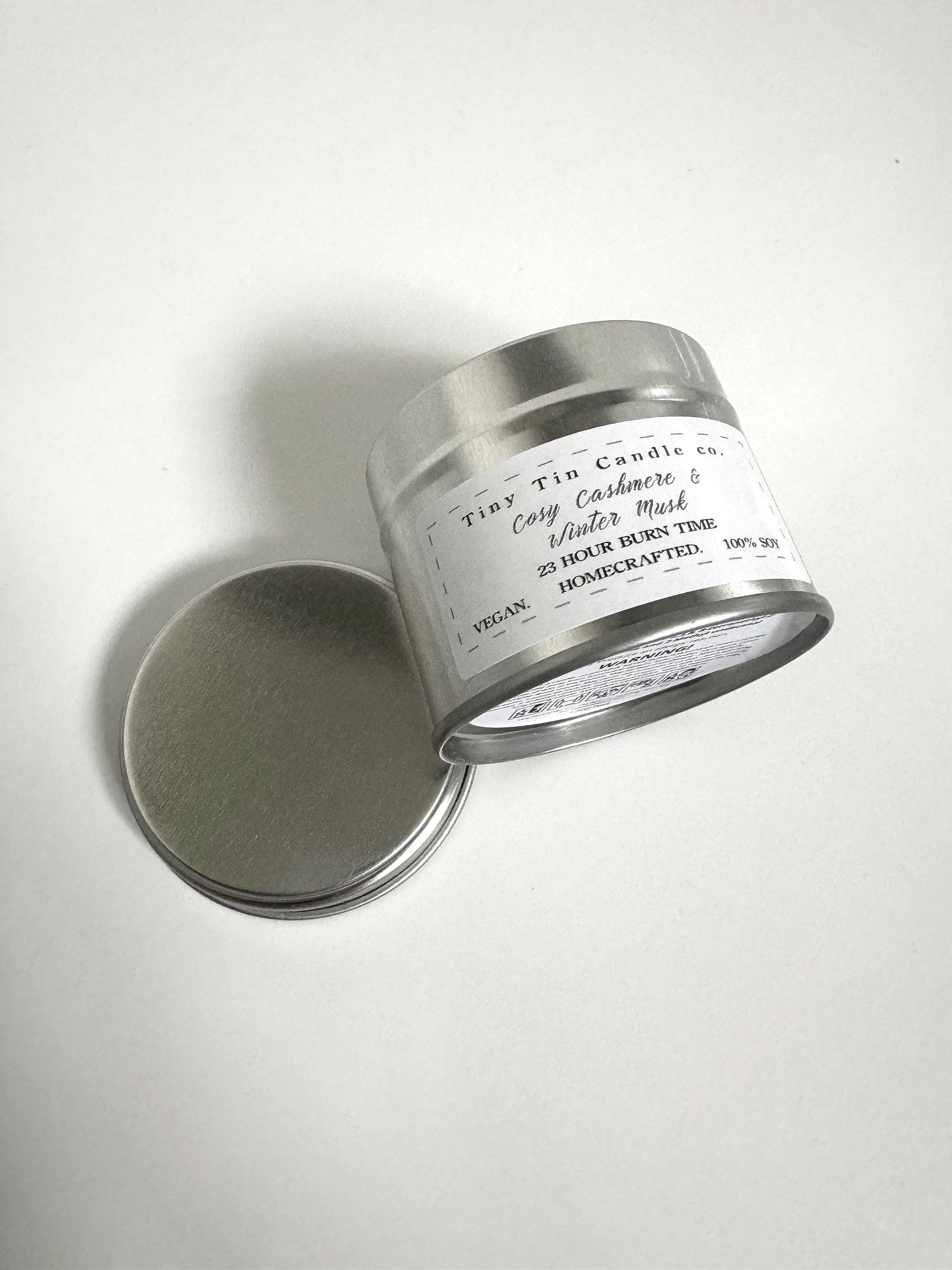 Homemade Candle Cosy Cashmere & Winter Musk 100ml Soy Tin Candle . top and front of candle with lid balancing next to candle