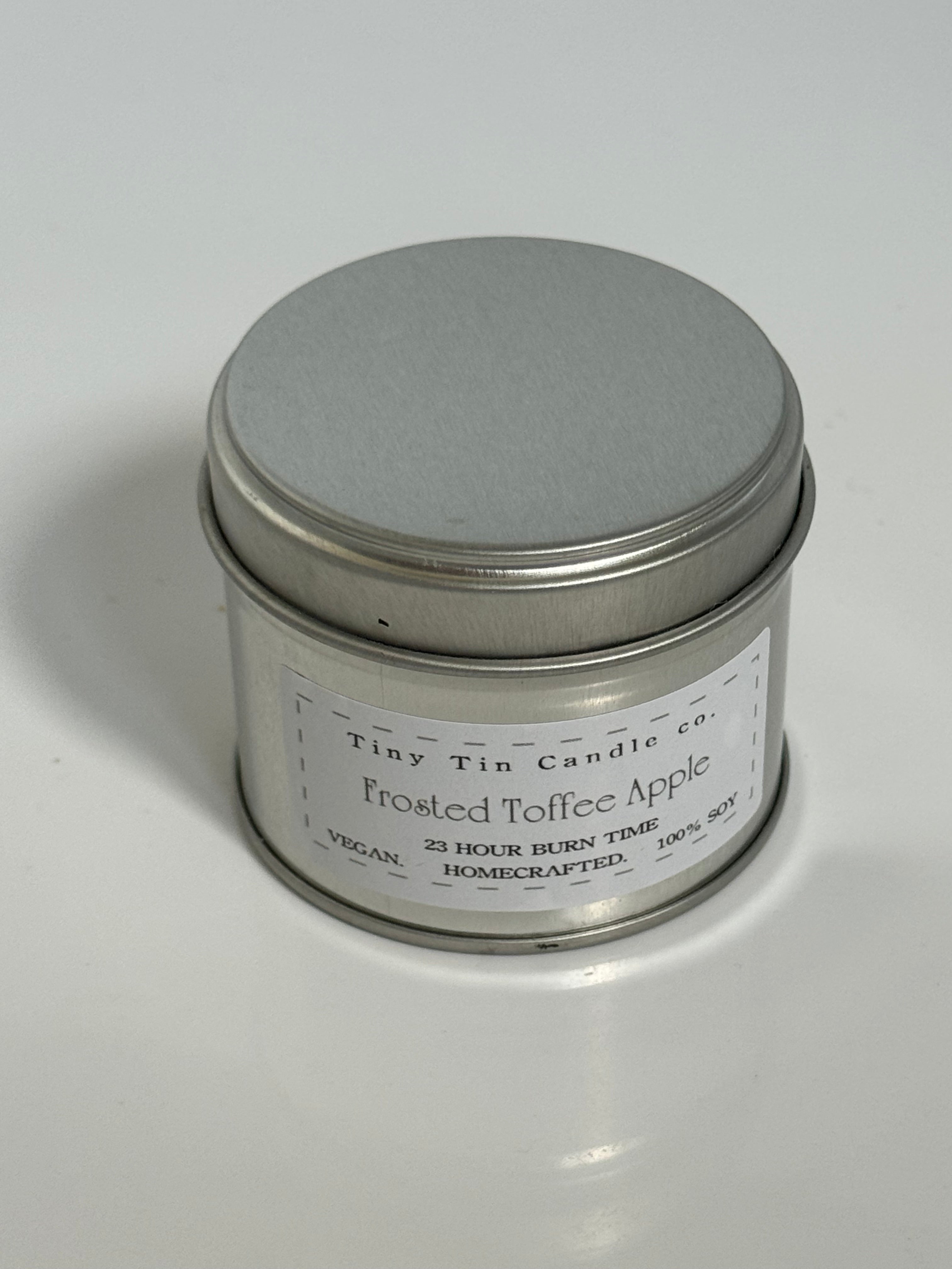 Homemade Candle Frosted Toffee Apple Soy Tin Candle 100ml . front of candle with lid on.